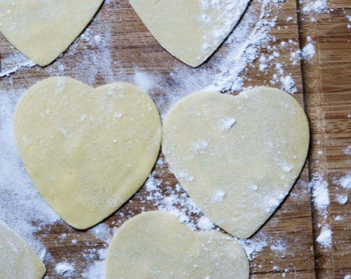 step 4 Roll out the dough into a 5 mm circle, then using a heart-shaped cookie cutter, cut out big hearts.
