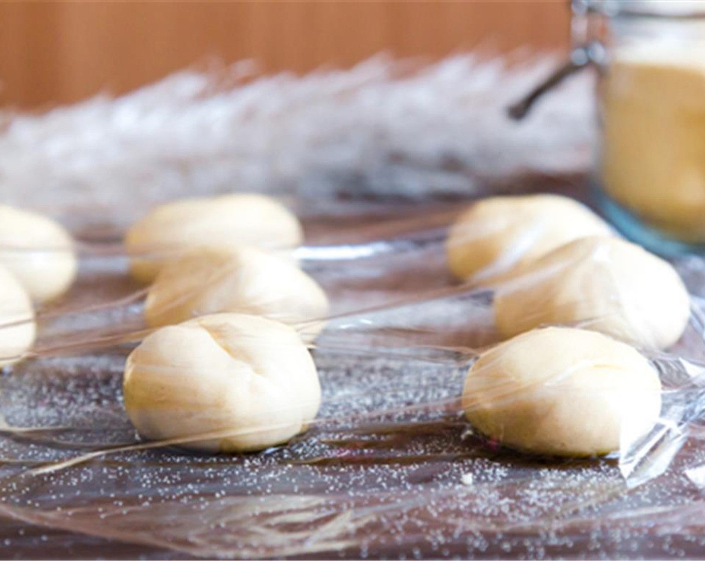 step 3 Once your dough is ready, divide the dough in small balls, place on a tray, lightly drizzle with some Vegetable Oil (2 Tbsp) and cover with cling film for 40 minutes in a warm place.