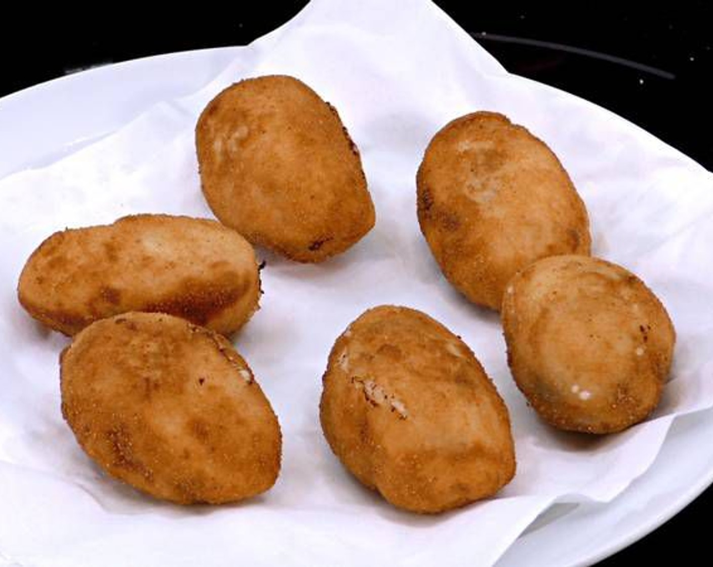 step 10 As the croquets become golden and heated through, transfer them to a plate with paper towels to drain the excess oil.