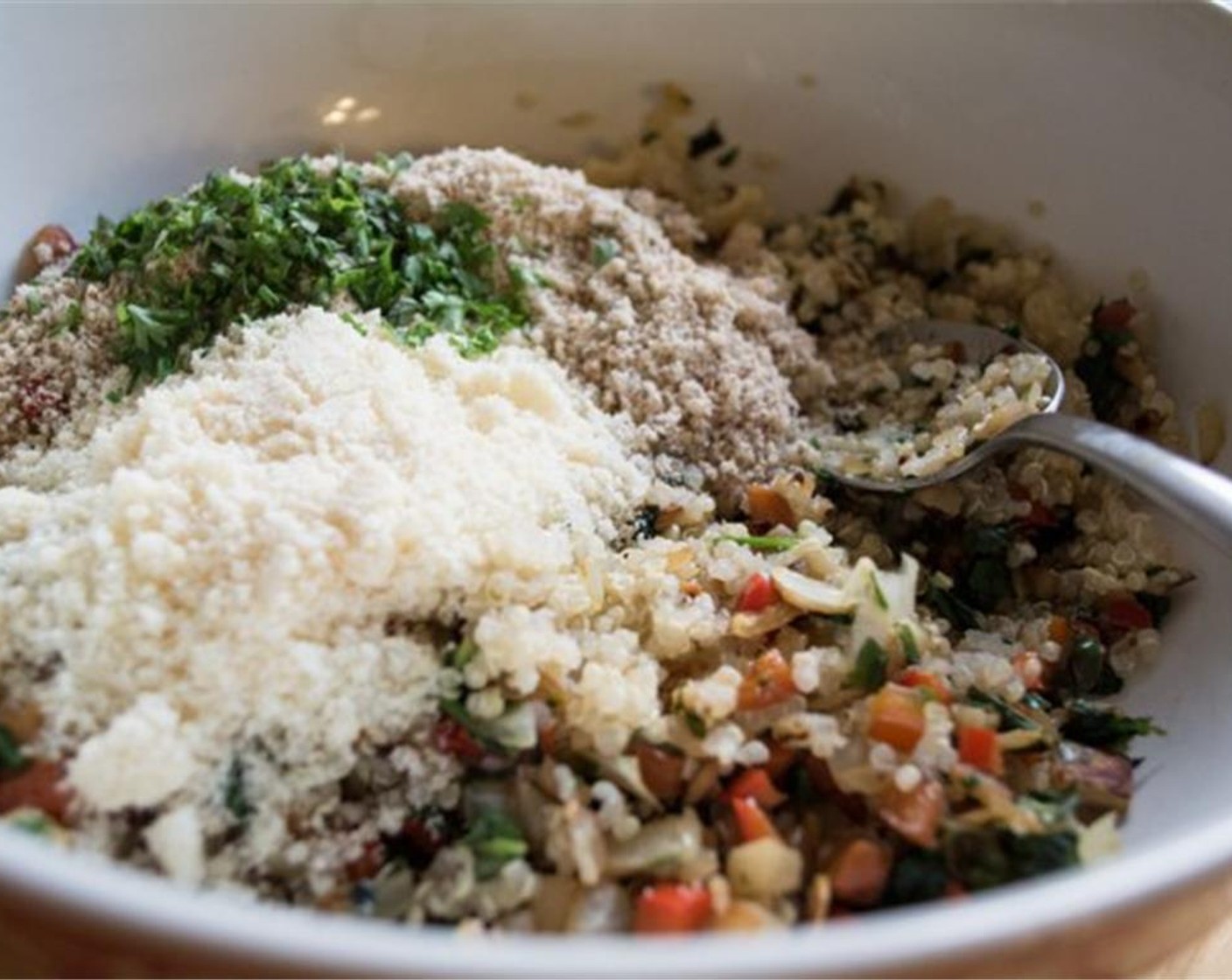 step 5 Add cooked quinoa to a large mixing bowl. Add in sautéed veggies and gently stir. In small bowl, mix Almond Meal (1/2 cup), Simply Organic Garlic Powder (1/2 tsp), Simply Organic Onion Powder (1/2 tsp) and Dried Oregano (1/2 tsp).