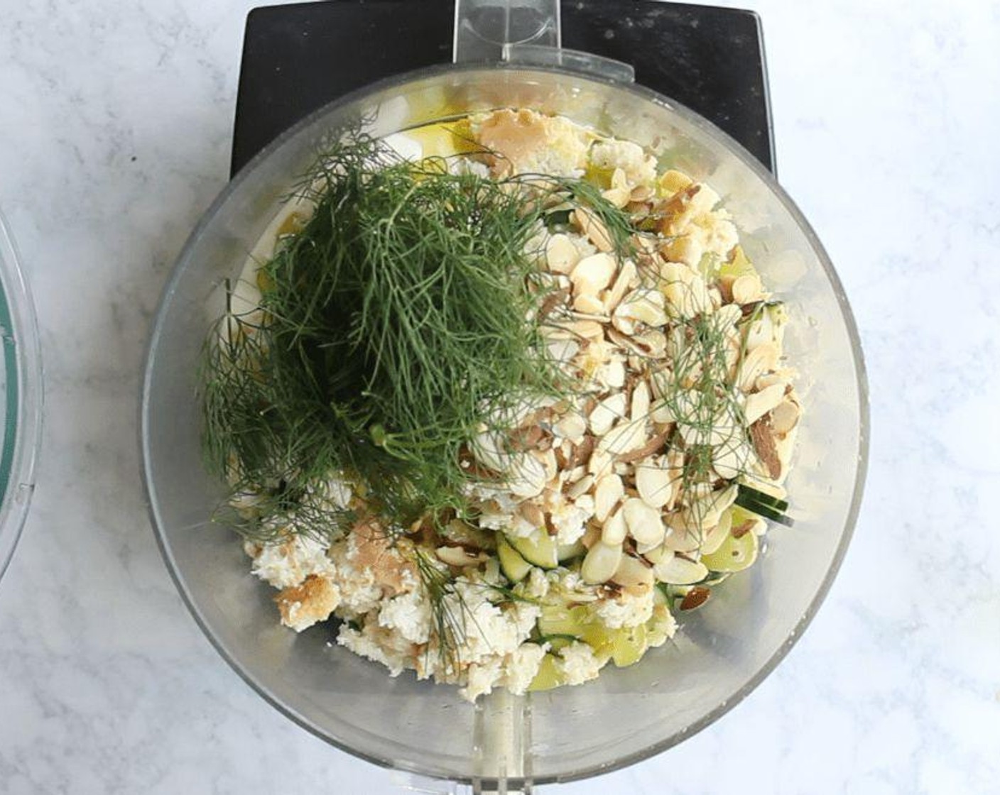 step 5 Add the almonds to a food processor and pulse until finely minced. Add the cucumber mixture, soaked bread, Fresh Dill (1/4 cup), Extra-Virgin Olive Oil (2 Tbsp), Yogurt (1/3 cup), and Freshly Ground Black Pepper (to taste) to the processor bowl.