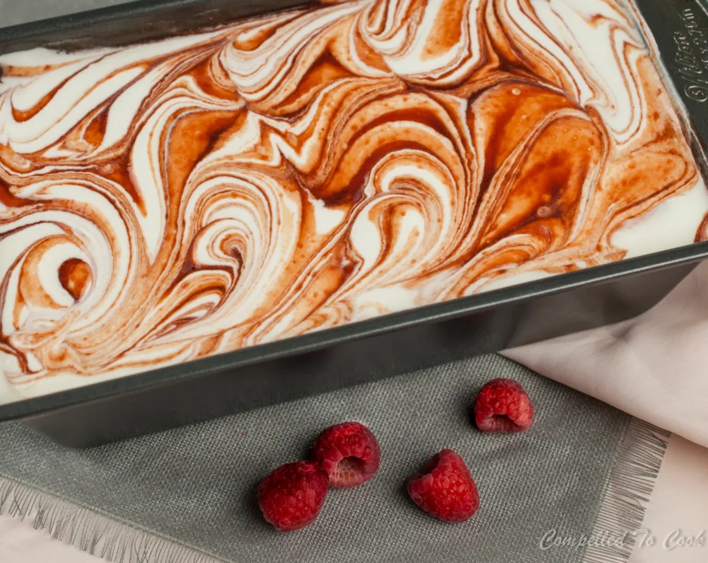 step 6 Pour half into a 9x5-inch loaf pan. Drizzle half the raspberry sauce over the cream mixture. Pour remaining cream mixture over to cover completely. Top with remaining raspberry sauce and swirl using a bread knife.