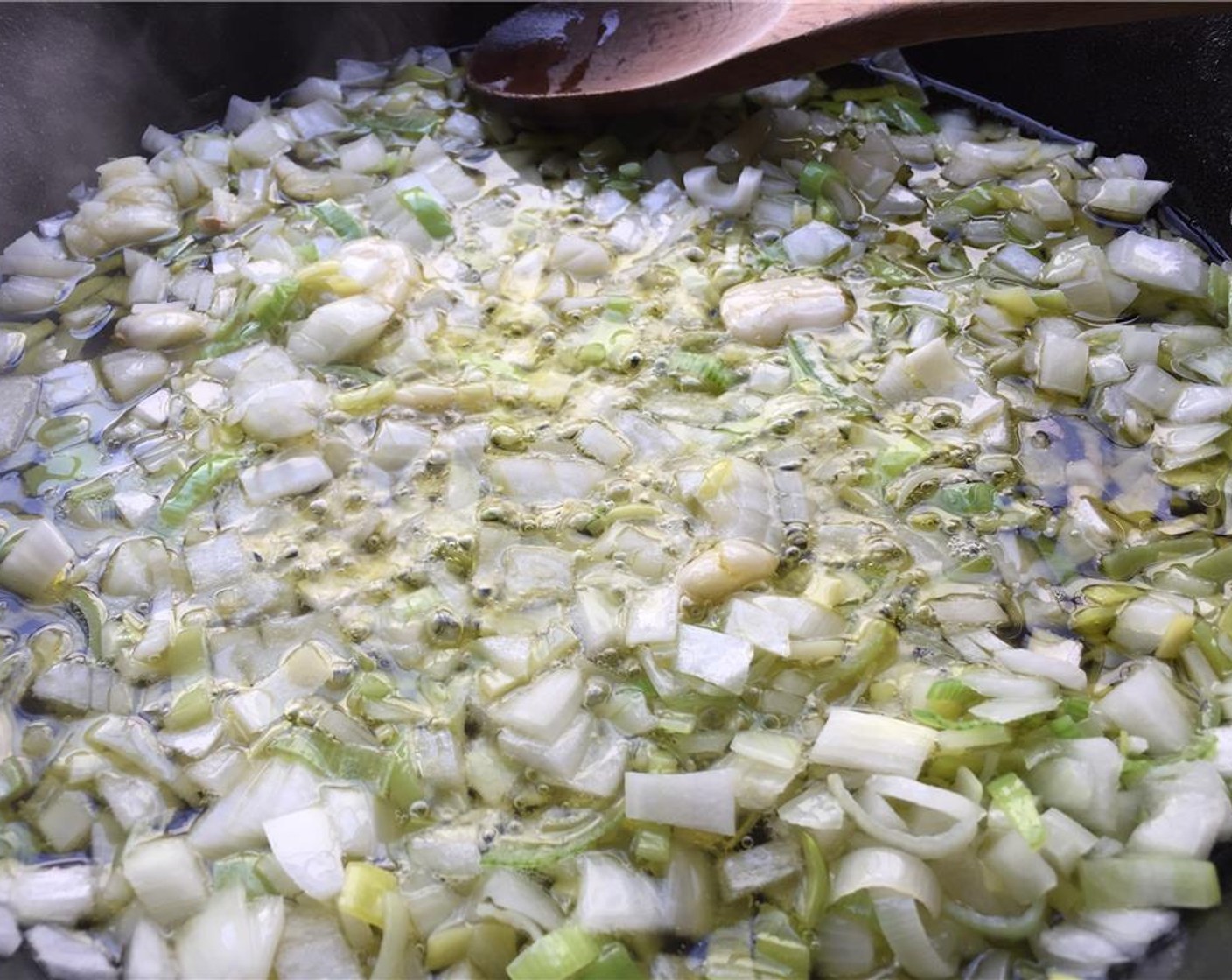 step 5 Heat the Extra-Virgin Olive Oil (1 cup) in a small pot and add the chopped leek, chopped onion, and smashed garlic cloves. Cook for 5 minutes.