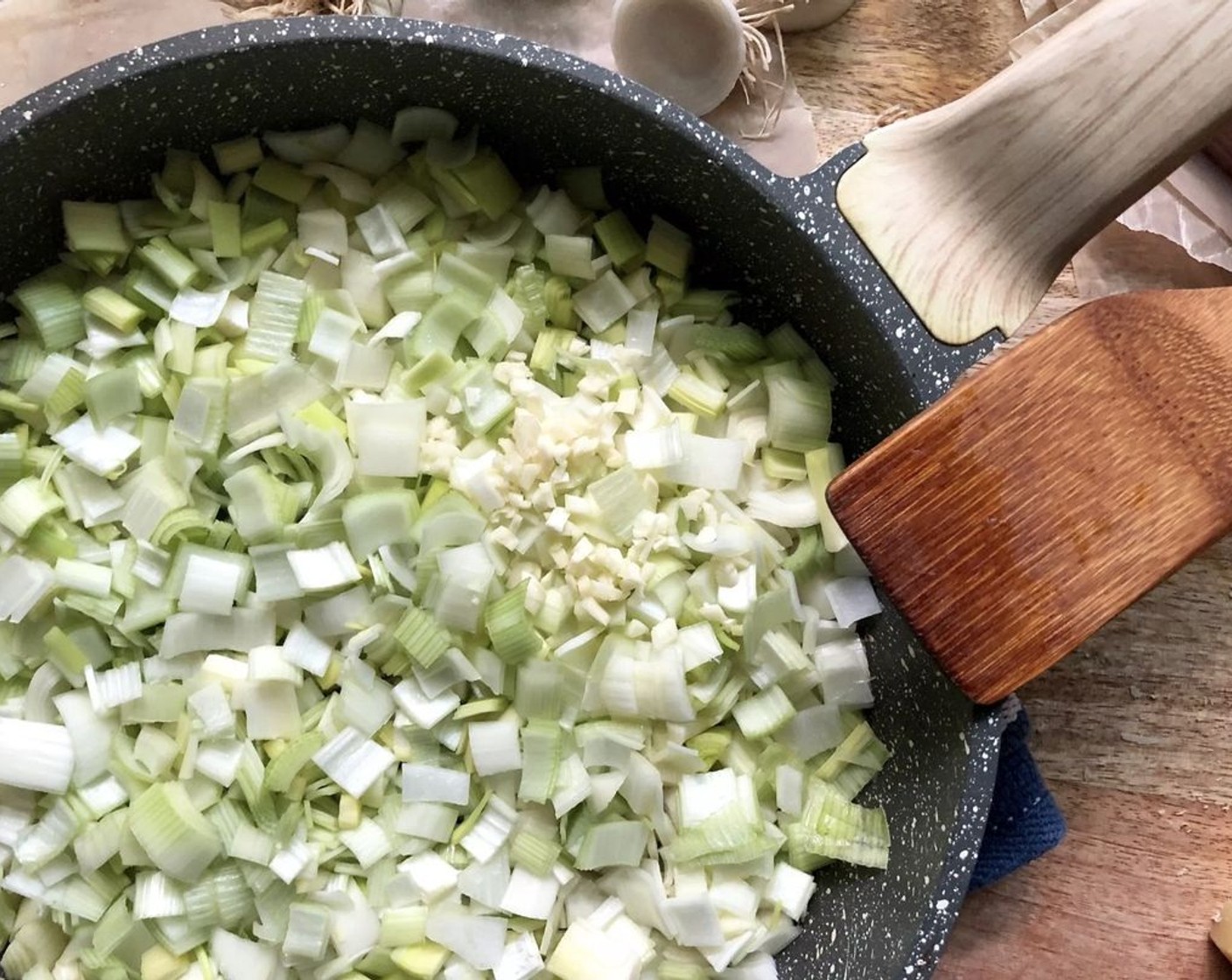 step 5 For the filling, heat the Unsalted Butter (2 Tbsp) and Olive Oil (2 Tbsp) over medium-high heat in a medium-large saucepan. Add the Leeks (4 cups) and Garlic (2 cloves). Cook and stir 3-4 minutes or until tender.