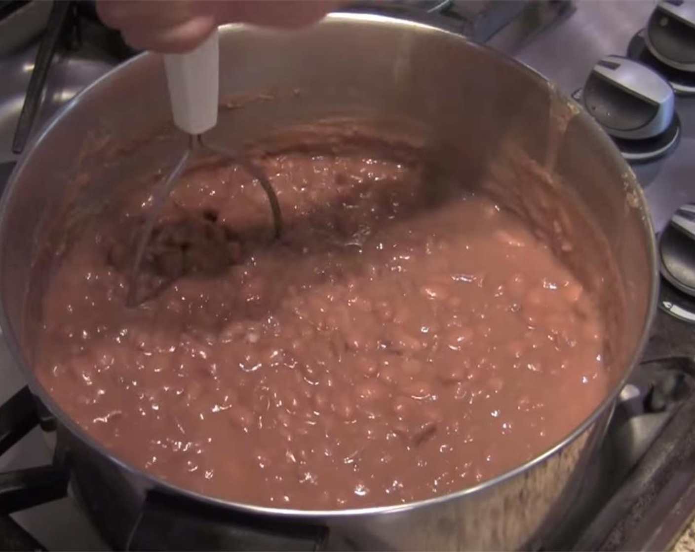 step 5 Turn off heat, and mash beans using a potato masher to desired consistency.