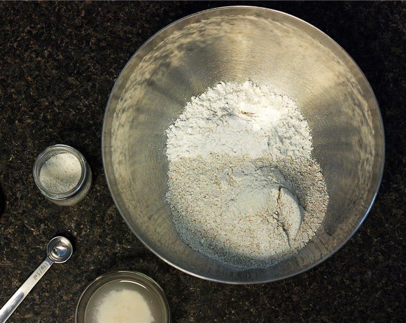 step 2 Combine Whole Wheat Flour (1 1/2 cups), All-Purpose Flour (2 1/2 cups), and Coarse Salt (1 tsp) in a large mixing bowl and mix well with a fork. Add the yeast mixture and the remaining warm Water (1 cup). Stir to make a sticky dough.
