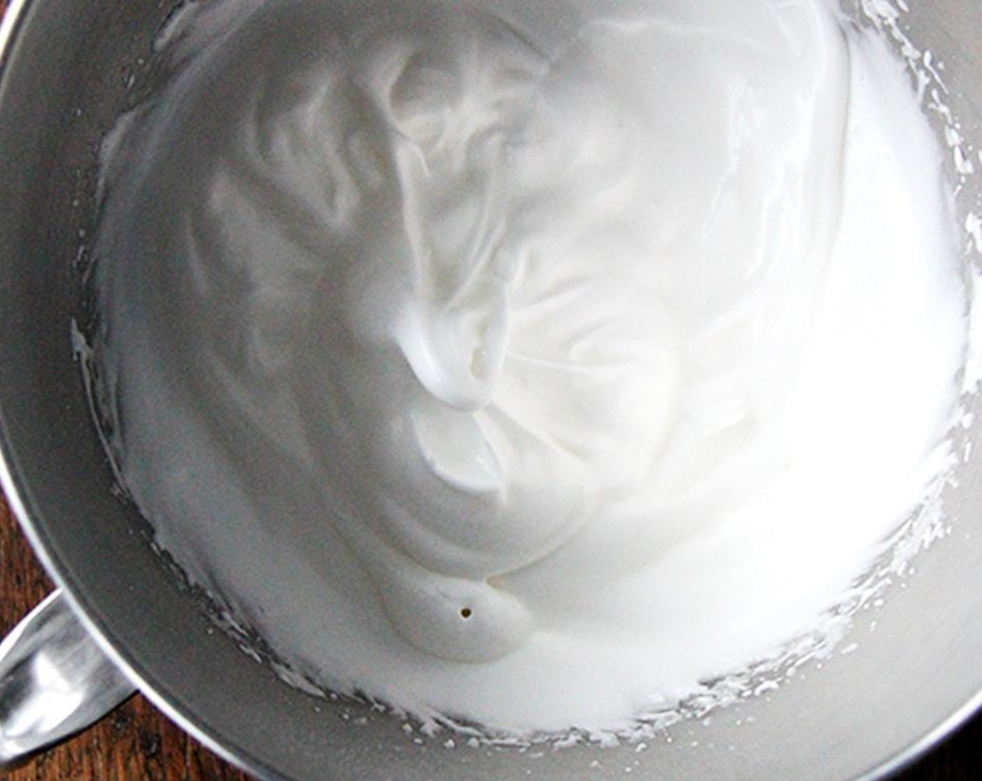 step 6 In a separate bowl, beat the egg whites with Salt (1 pinch) until frothy. Continue to beat until they start to hold their shape. Add 1 tablespoon of sugar and continue to beat until thick and shiny, but not completely stiff. Then add the Vanilla Extract (1 tsp).