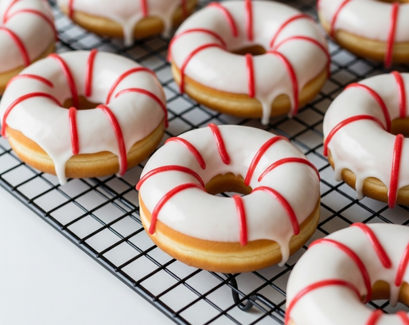 step 21 For themed doughnuts, use red icing (gel, piping icing, or candy melts) to pipe four evenly spaced stripes around the edge of each one to mimic the look of a lifebuoy ring.
