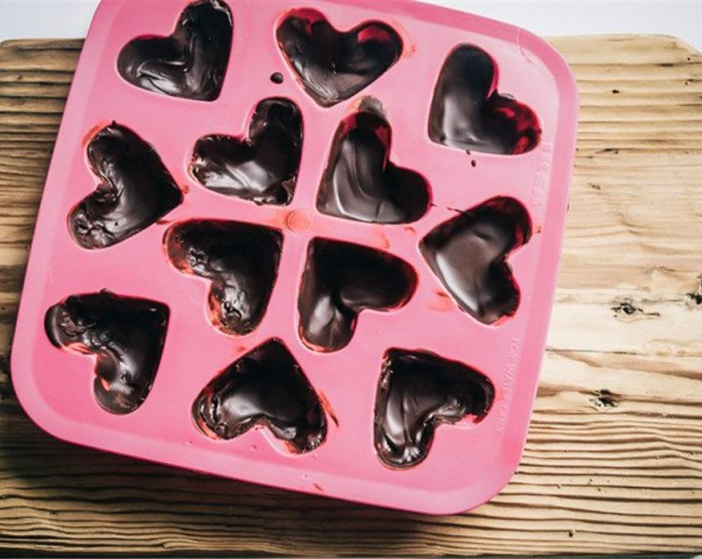 step 6 Tilt your chocolate mold or muffin tin slightly in all directions so the chocolate begins to coat the sides. Add mold to freezer for approximately ten minutes to allow chocolate to harden.