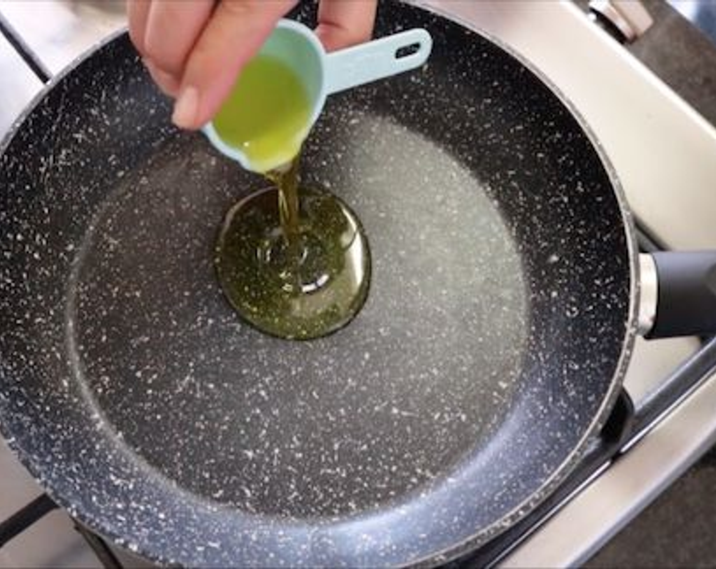 step 7 Heat a non-stick frying pan with a medium heat and add Extra-Virgin Olive Oil (2 Tbsp), about 1 minute later add the slices of garlic and spicy pepper and mix with the oil. 2 minutes later add the 1/4 cup of capers and cook for an additional 2 minutes.