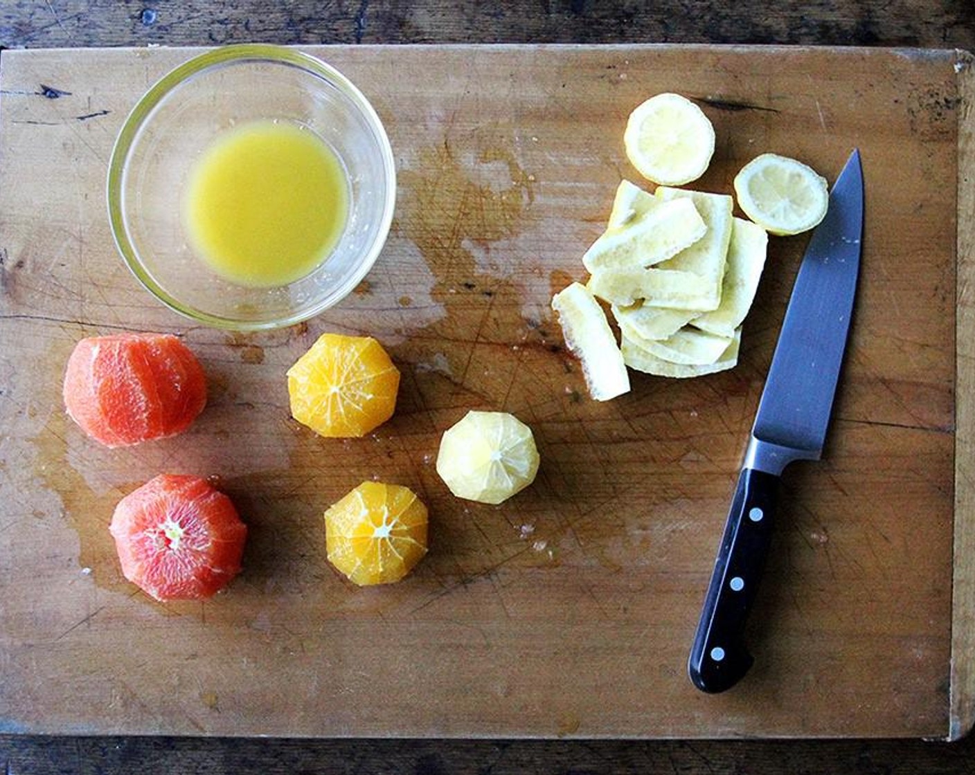 step 2 Slice off the ends of each Oranges (4) and the Lemon (1). Squeeze the juice out of those ends into a medium bowl. Discard the rind. Stand each piece of fruit on one of its cut sides. Run a knife down the side of each orange and the lemon to remove the skin.