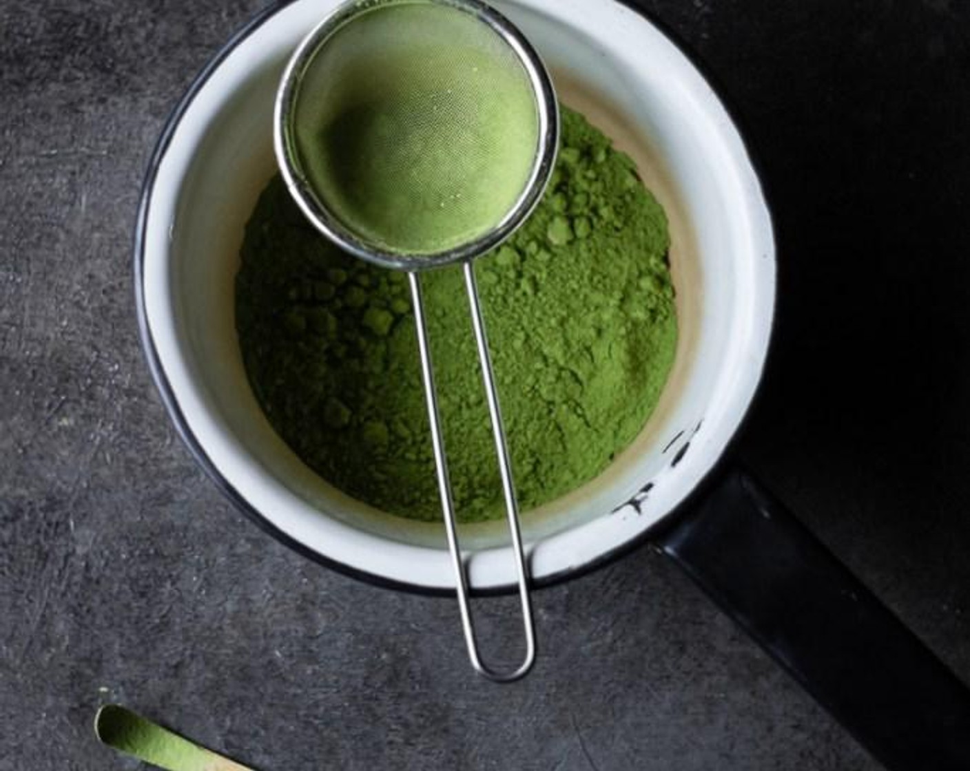 step 1 For the Matcha White Hot Chocolate: Using a fine mesh sifter, sift Matcha Powder (1 Tbsp) into a saucepan. Add Water (8 fl oz) to saucepan and whisk matcha with hot water until very smooth and no lumps remain.