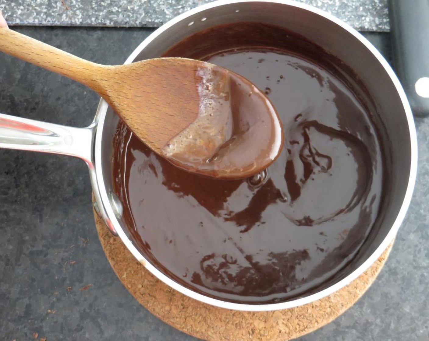 step 11 Pour hot heavy cream over chocolate and let sit for a few minutes until chocolate softens. Use a whisk to carefully incorporate the heavy cream into the semi-sweet chocolate until glistening and smooth.