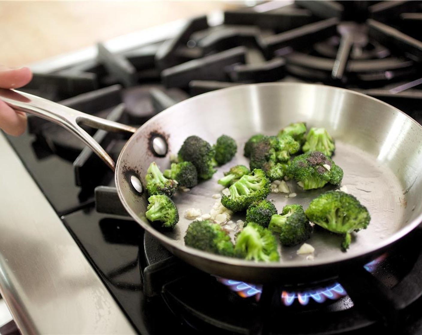 step 11 In a medium saute pan over medium high heat, add 1 teaspoon of olive oil, remaining garlic, and Broccoli Florets (1 cup). Cook for 2 minutes.