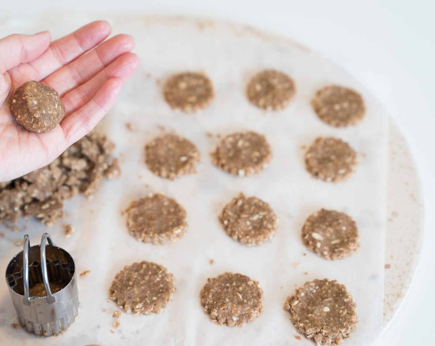 step 6 Grease a cookie sheet or line with parchment paper. Form the cookies into small balls and then flatten with a fork or your fingers.