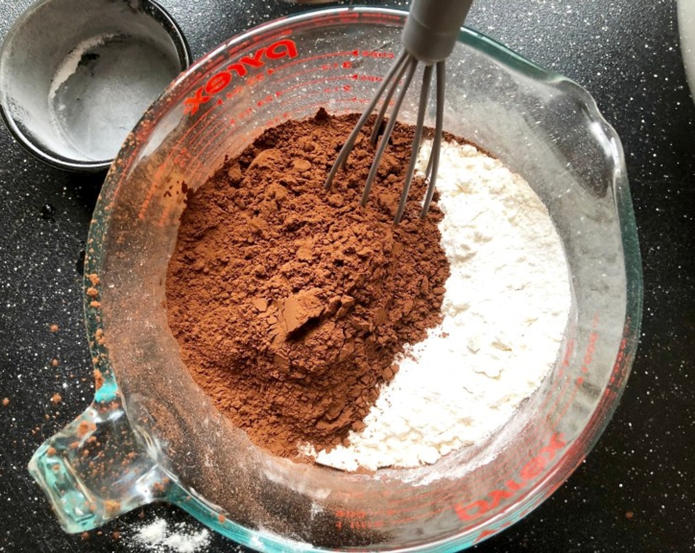 step 4 Meanwhile, add the All-Purpose Flour (1 1/2 cups), Baking Powder (1/2 Tbsp), and Salt (1/4 tsp) to a medium bowl. Add Unsweetened Cocoa Powder (3/4 cup) and whisk until well incorporated.