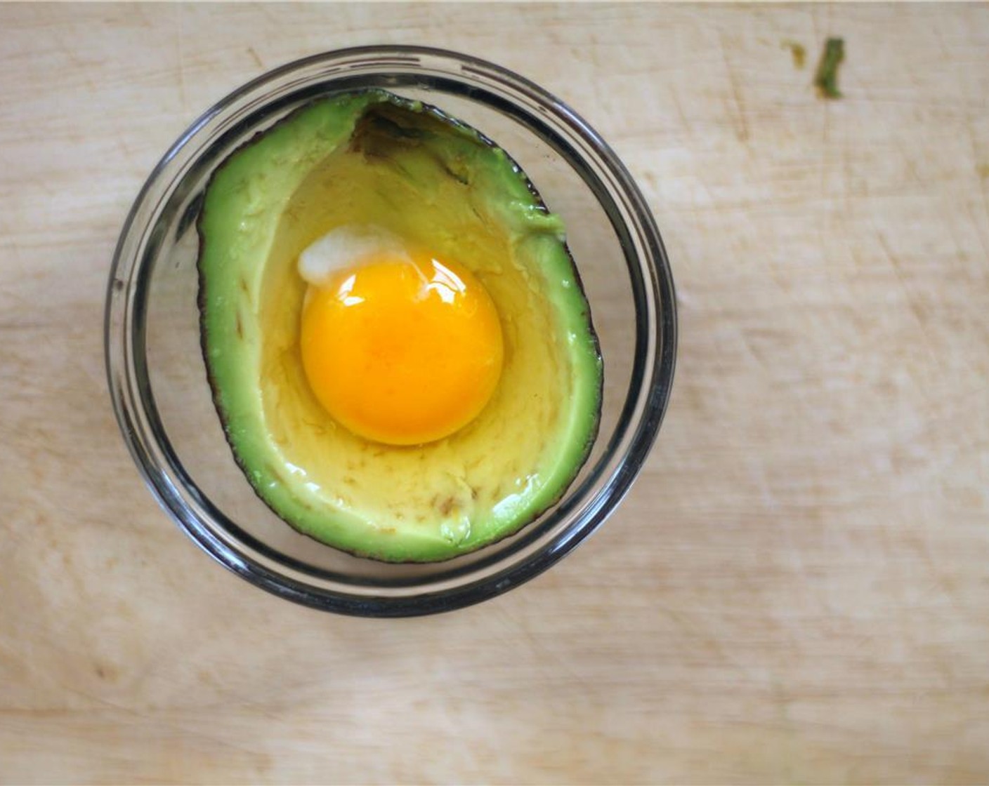 step 3 Crack the Eggs (2) and separate the egg yolk from the egg white. Fill the avocado with the yolk first, then add the right amount of the white to prevent it from overflowing.