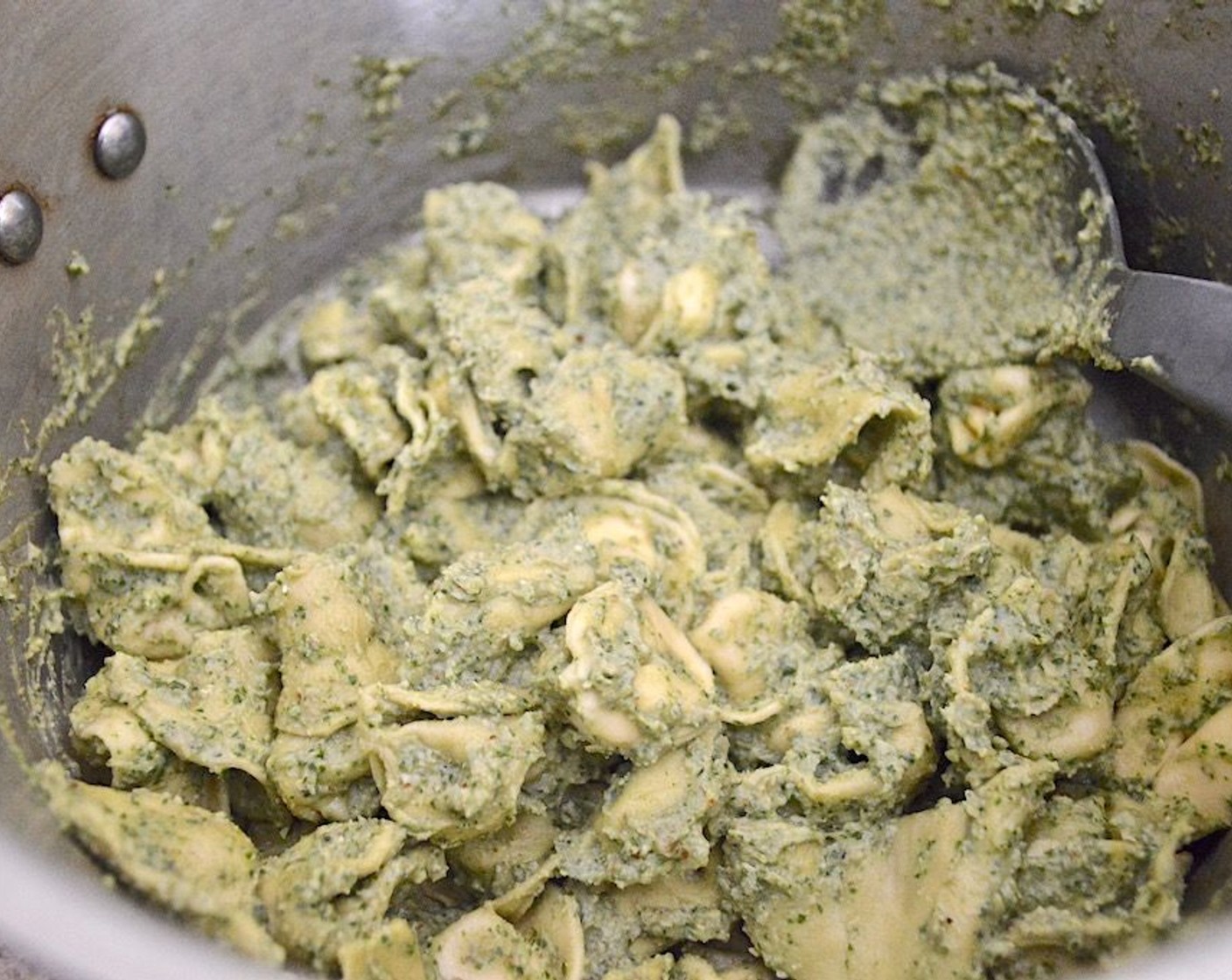 step 5 Toss the tortellini and pesto together, then pour in the water and an extra drizzle of olive oil and stir them in to loosen everything up.