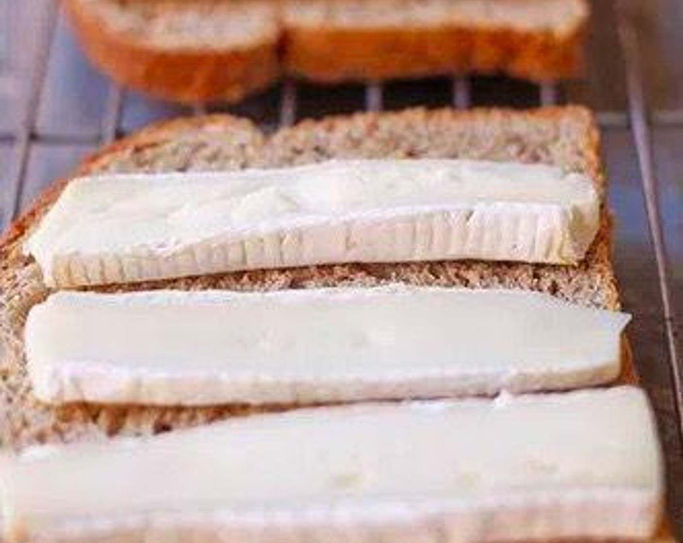 step 1 Place Brie Cheese (3 oz) on Country White Bread (2 slices) and place bread on toaster oven rack.