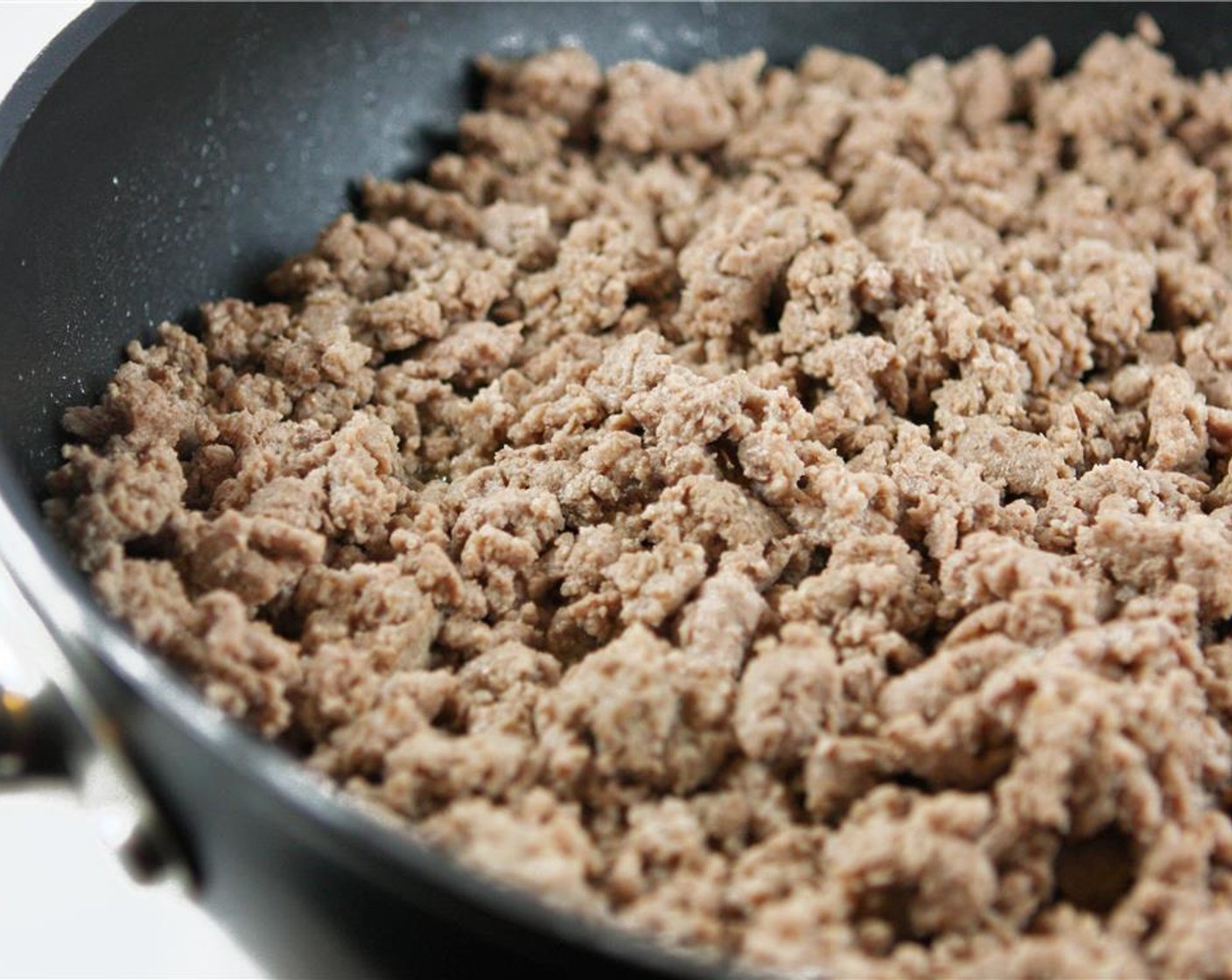 step 1 In a large skillet, cook Ground Beef (2 lb) over medium-high heat until no longer pink. Transfer the meat to a bowl. Drain excess grease from the skillet, but do not clean.