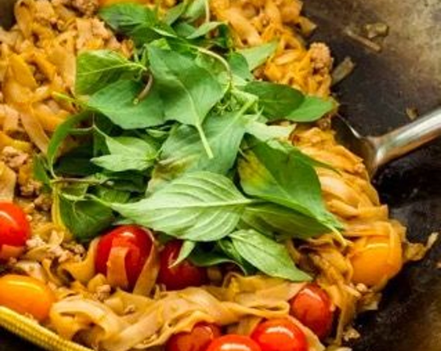 step 6 Return the cooked ground pork to the wok. Add Cherry Tomatoes (2 cups) and Fresh Thai Basil (2 cups) to the noodles. Stir to combine all the ingredients.