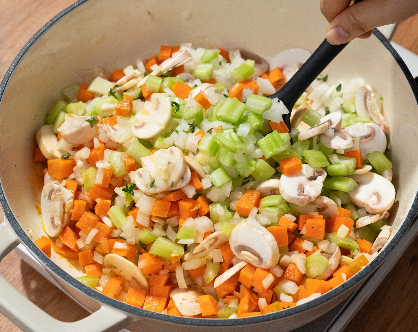 step 3 In the same pot, add Butter (2 Tbsp), Button Mushroom (1 cup), Yellow Onion (1), Celery (3 stalks), Carrots (2), Garlic (2 cloves), and Fresh Thyme (4 sprigs) leaves. Saute over medium heat for about 5 minutes. Then season with Salt (1/2 tsp) and Ground Black Pepper (1/2 tsp).