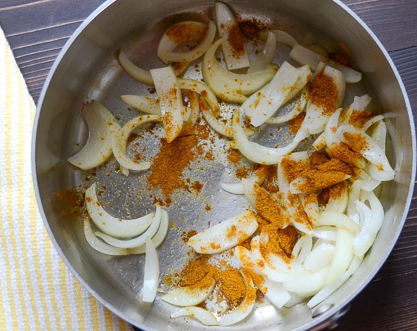 step 3 In a medium saucepan, heat the Olive Oil (1 Tbsp) over medium heat. Add the Onion (1) and sprinkle with Salt (1/4 tsp). Cook the onions for 3 to 4 minutes until they start to soften. Sprinkle in the Curry Powder (1 tsp).