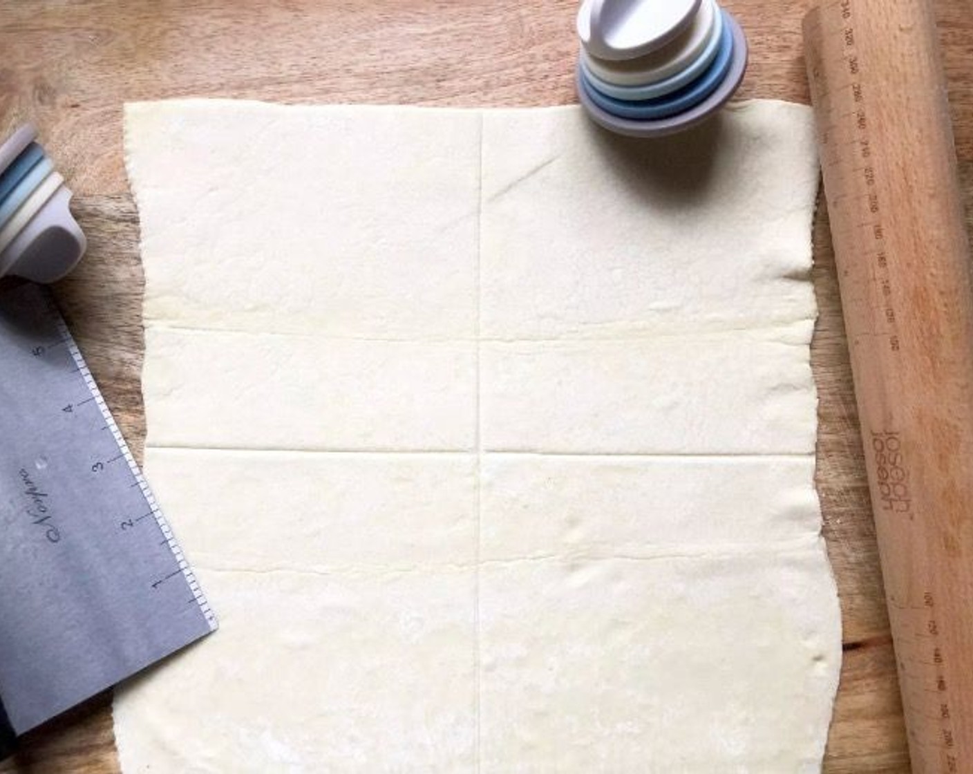 step 3 Lightly roll out the Puff Pastry (1 sheet) so that it forms a 10 1/2-inch square. Cut it into four equal squares.