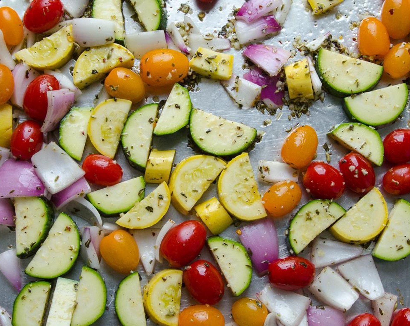 step 4 On a large baking sheet combine the Zucchini (1), Yellow Squash (1), Red Onion (1), Grape Tomatoes (3 cups), {@10:}, Dried Basil (1 tsp), Dried Oregano (1 tsp), Crushed Red Pepper Flakes (1/4 tsp), Olive Oil (3 Tbsp), Kosher Salt (3/4 tsp) and Ground Black Pepper (1/2 tsp). Toss to combine.