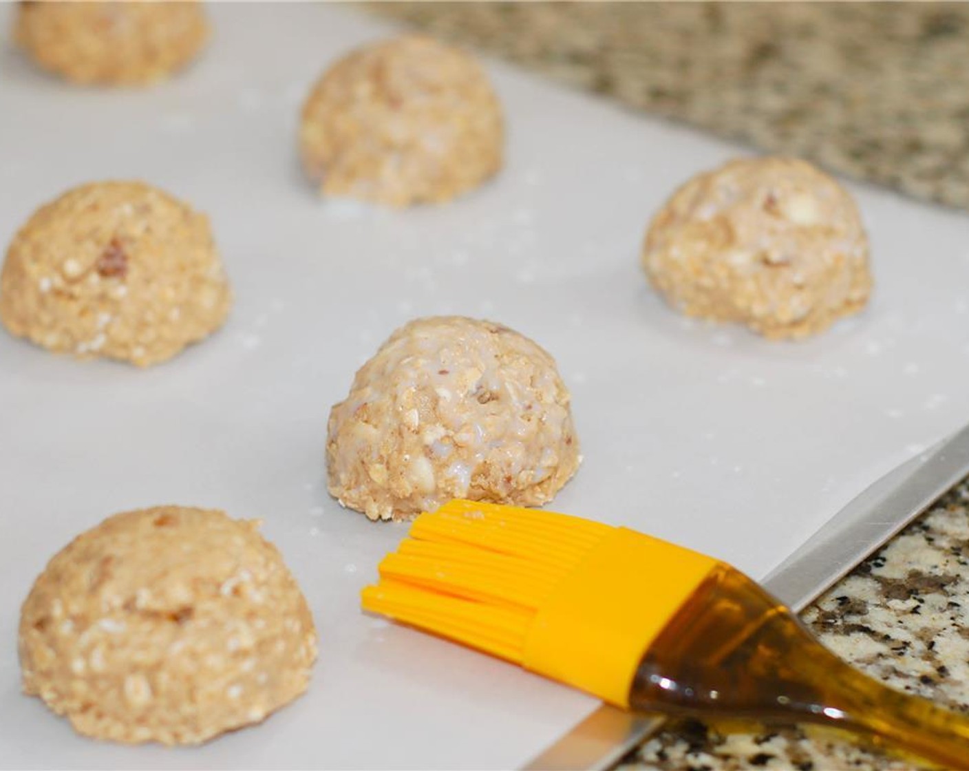 step 5 With a large scoop, place dough onto a greased cookie sheet. Do not flatten. Brush the tops and sides of each scone with Milk (2 Tbsp) and then sprinkle with Granulated Sugar (1 tsp).