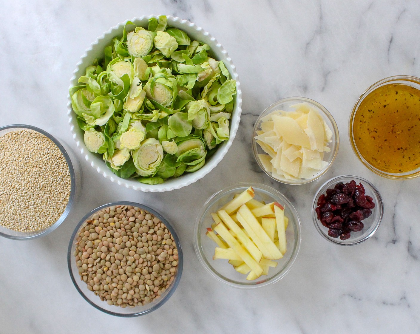 step 3 While the lentils and quinoa cook, combine the Brussels Sprouts (2 bags), Apple (1), Dried Cranberries (1/4 cup), and Shredded Parmesan Cheese (1/2 cup) in a large bowl. Set aside.