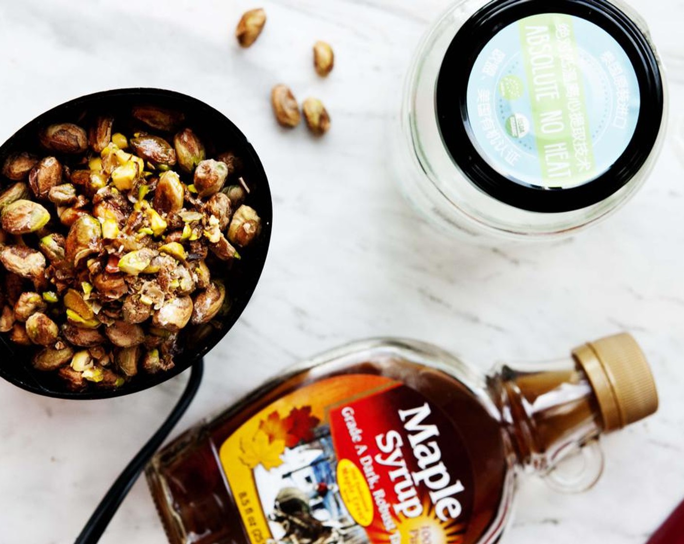 step 1 In your coffee grinder or food processor, place unshelled Unsalted Pistachios (4 cups), Coconut Oil (1 Tbsp), Maple Syrup (1 Tbsp), and Water (4 Tbsp).