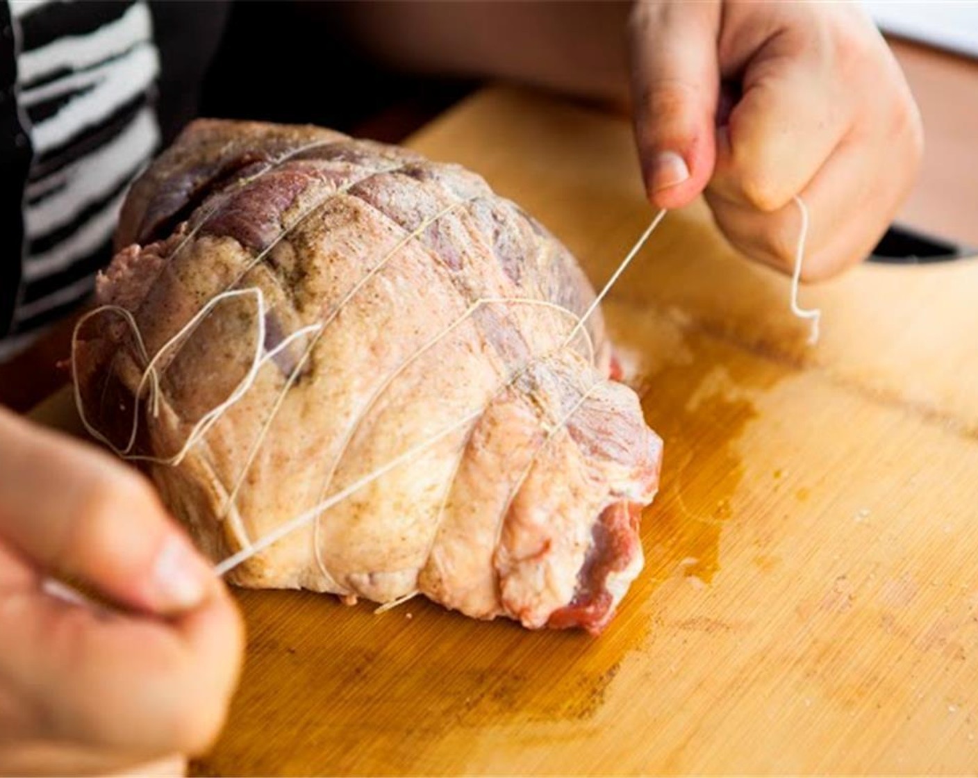 step 5 Using butcher's twine, tie it in several places, about 1 to 2 inches apart. Brush with Extra-Virgin Olive Oil (as needed) and season with salt and pepper.