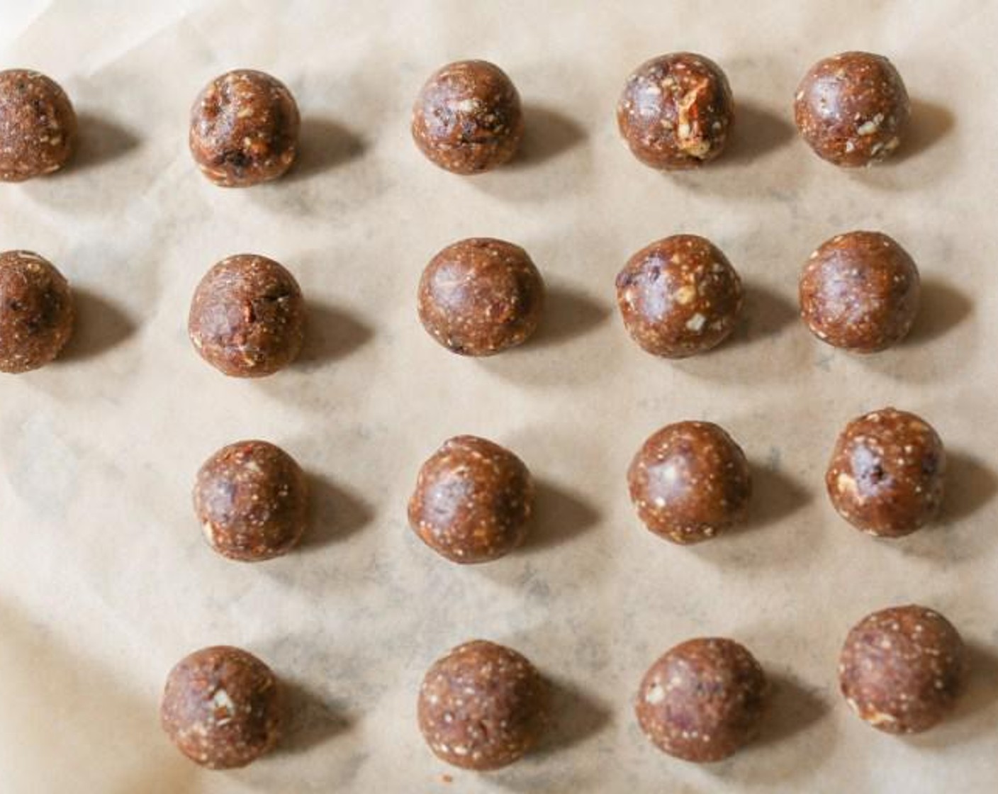 step 3 Line a baking sheet with parchment paper. With damp hand, roll heaping tablespoons of the truffle mixture into balls and place them on the prepared baking sheet.