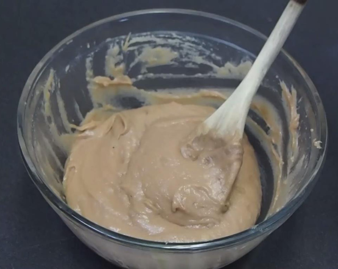 step 4 Unwrap and work the dough with the back of a wooden spoon. Smash and stretch the dough until it gets thick, sticky, and cohesive.