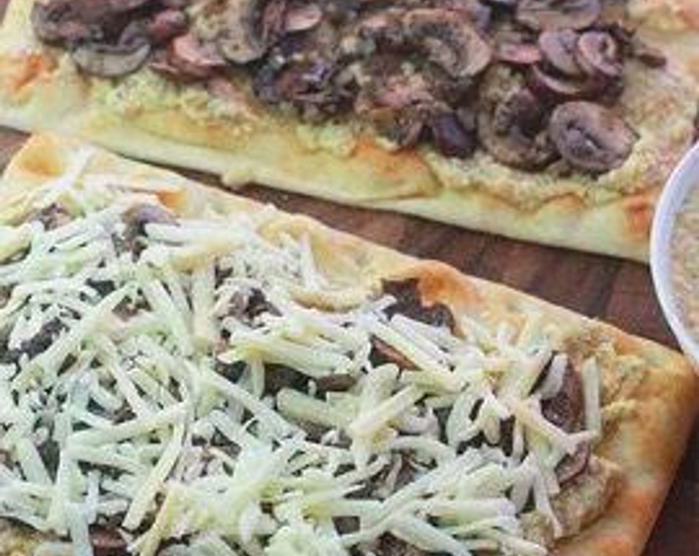 step 3 Place Naans (2 slices) on a parchment-lined baking sheet. Spread Artichoke Pesto (1/4 cup) over flatbread. Spread mushrooms over pesto. Sprinkle Mozzarella Cheese (1 cup) over mushrooms. Bake flatbreads until cheese is melted and crust is golden brown, about 7 minutes.
