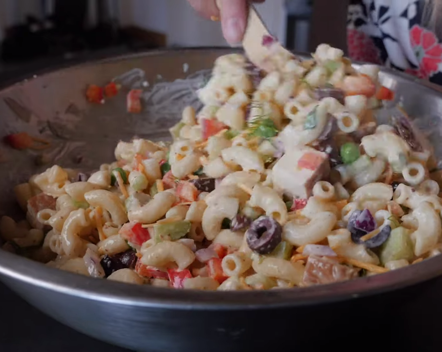 step 3 Stir in the cooked pasta, Frozen Green Peas (1/4 cup), Red Bell Pepper (1/2), Kalamata Olives (1/4 cup), Red Onion (1/4 cup), Celery (1 stalk), Vegan Cheddar Cheese (1/3 cup), Smoked Tofu (1/2 block), and season with Sea Salt (to taste) and Ground Black Pepper (to taste).