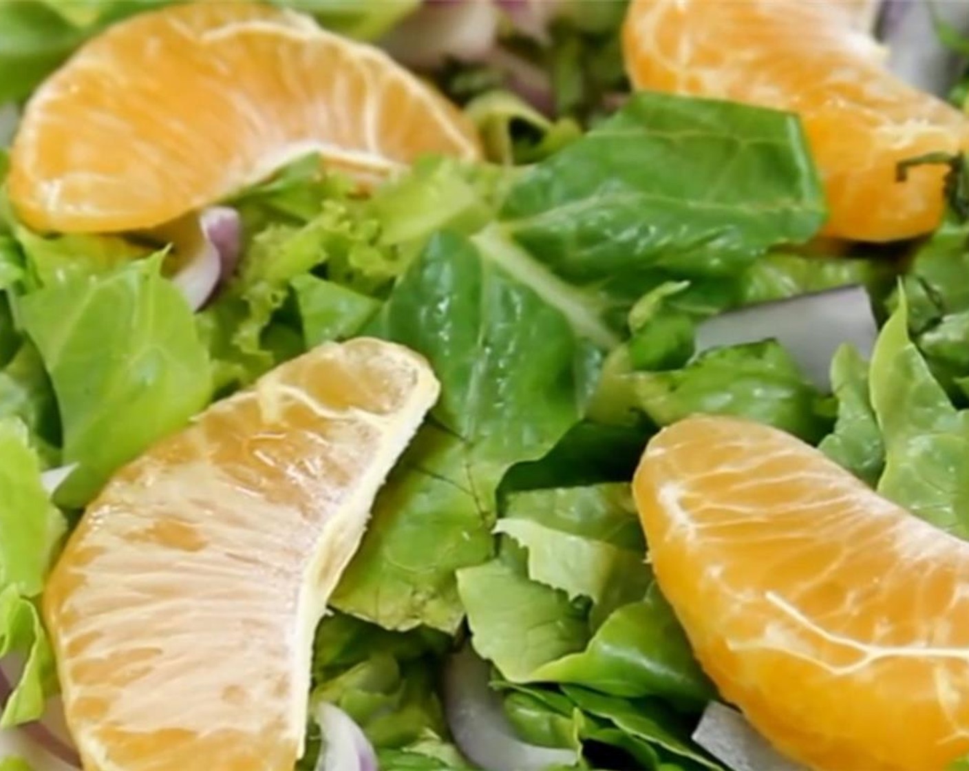 step 7 Layer the mandarin orange and red onion over the romaine lettuce.