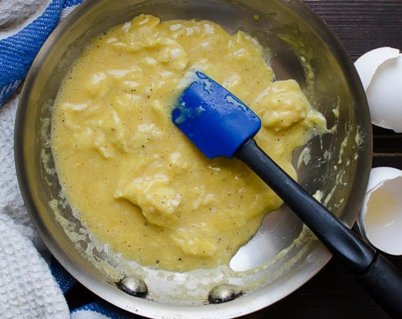 step 2 Using a silicone spatula drag the spatula across the pan like a clock face: from 12 to 6, 1 to 7, 2 to 8, 3-9, 4-10, 5-11 scraping the bottom of the pan with each drag. The eggs will cook slowly and as you drag them across the pan, large soft curds will begin to form.