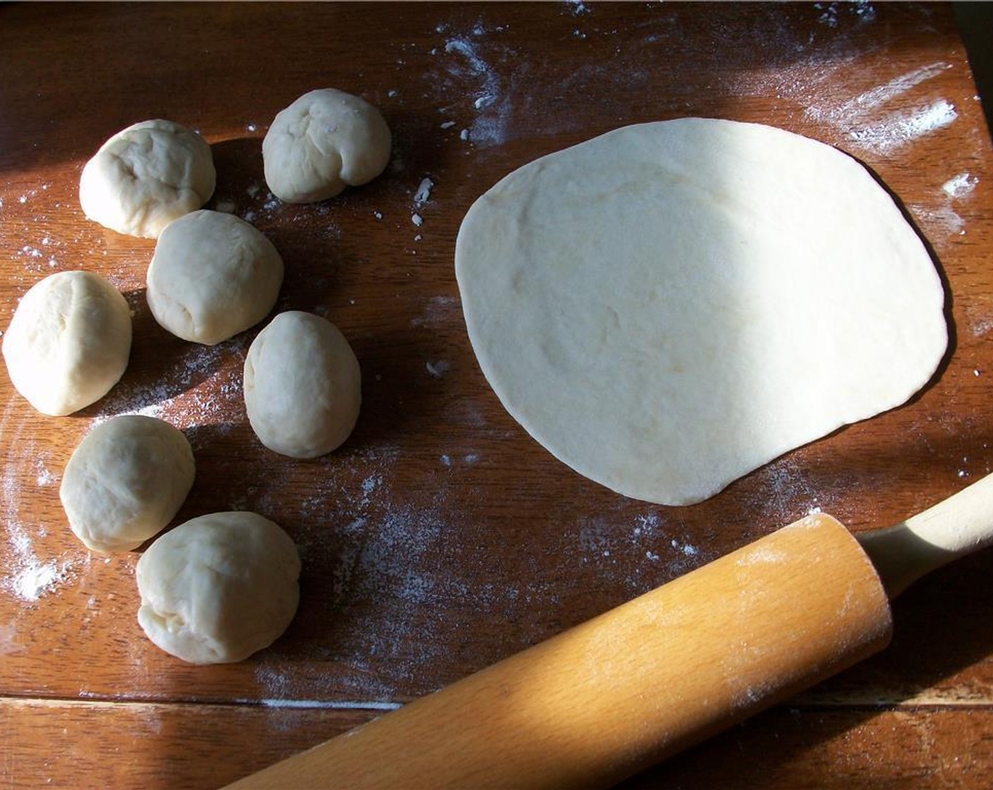 step 4 Divide into 8 equal pieces and roll into a ball. Using a rolling pin, roll into 7 inch circles.