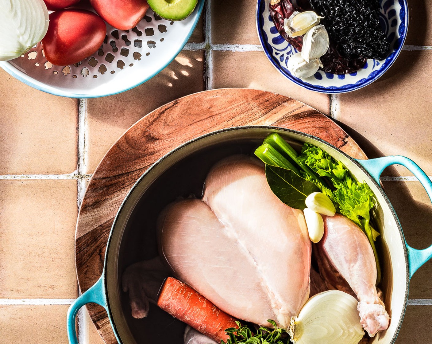 step 1 In a large pot, add the Whole Chicken (1) along with Water (8 cups), Bay Leaves (3), Garlic (3 cloves), Celery (4 sticks), White Onion (1/2), Carrot (1), Kosher Salt (3 Tbsp), Fresh Oregano (1 Tbsp), and Ground Black Pepper (to taste) Bring to a boil and then simmer for 1 1/2 hours.