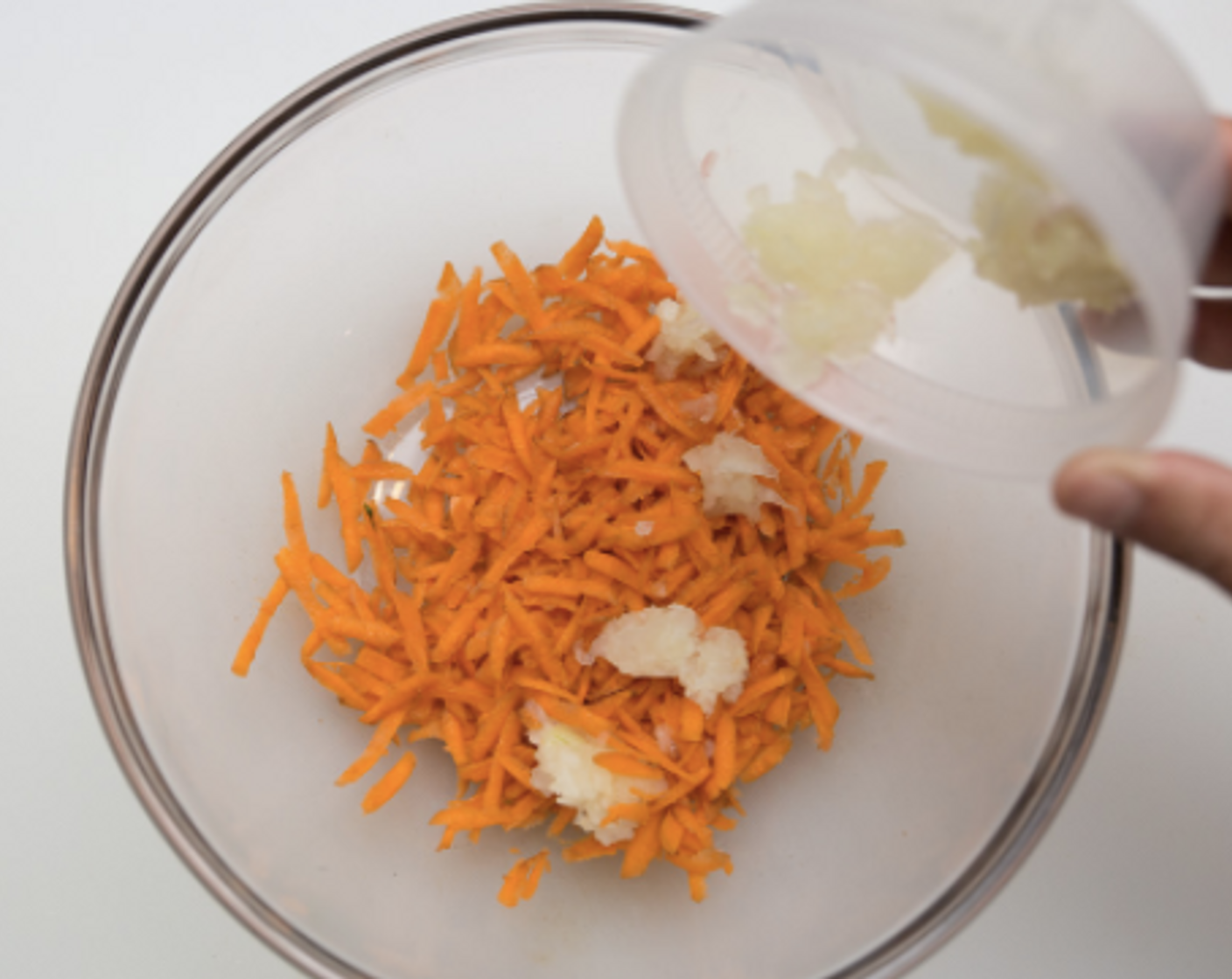 step 7 While greens are simmering, make meatloaf: In a mixing bowl combine Ground Turkey (12 oz), carrot, measured onion, Salt (1/4 tsp) and remaining Liquid Aminos (1 pckg). Mix vigorously to thoroughly combine.