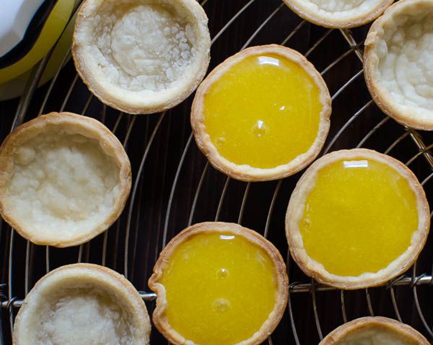 step 12 Use a pastry bag or small spoon to fill the tart cups with the lemon curd.