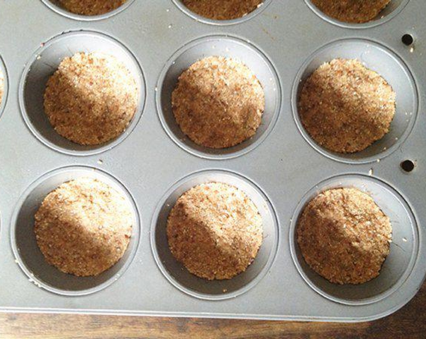 step 4 Line a mini (or regular) muffin tin with paper liners or use a silicone muffin holder. Portion the dough into each muffin cup and press down until even and smooth.