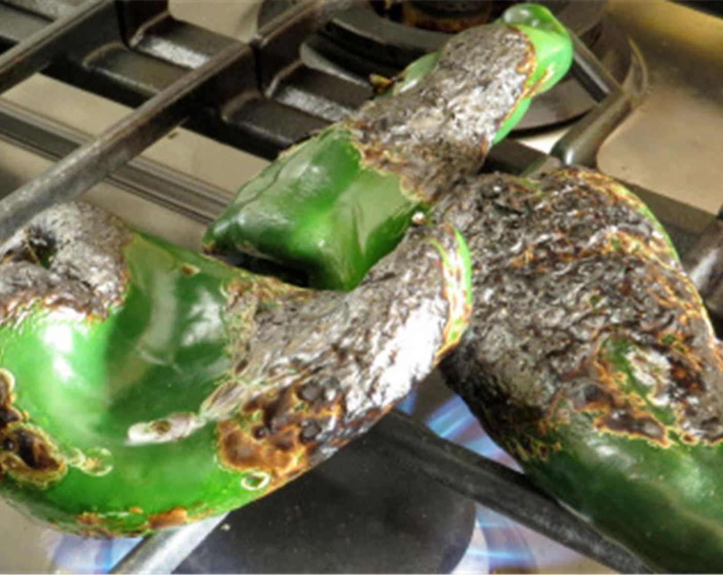 step 3 Place Poblano Peppers (3) directly over the gas of a gas stove or grill, and cook until skin is black and blistered all over. Place hot peppers in a brown paper bag and fold the top over tightly to steam peppers. Set aside.