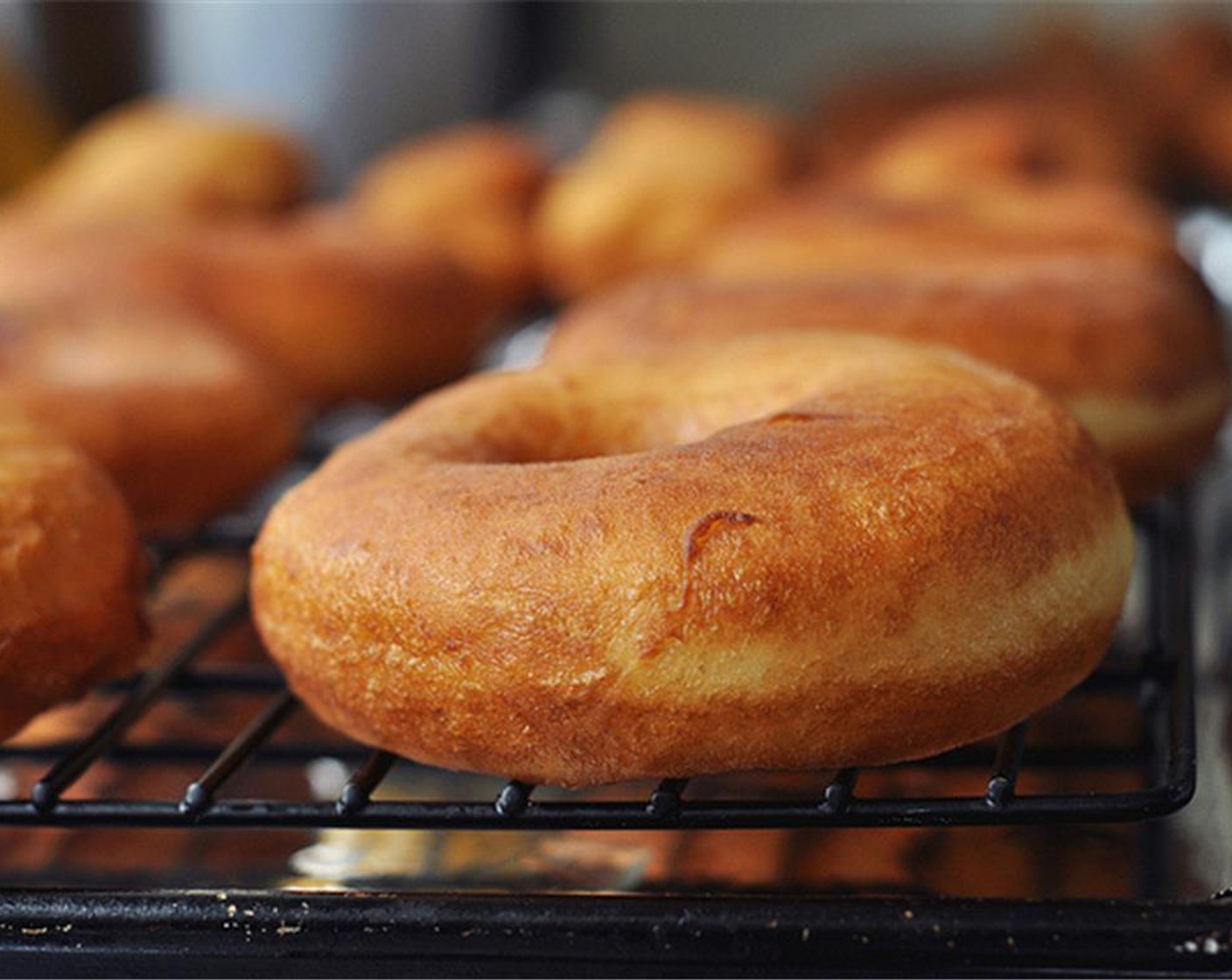 step 11 Fry for 1 to 2 minutes on each side, or until light golden brown. Drain the excess oil and transfer to a cooling rack. Continue until all the doughnuts are fried.