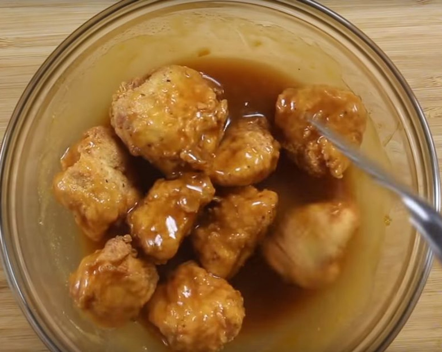 step 7 Coat the fried chicken chunks in the orange syrup.