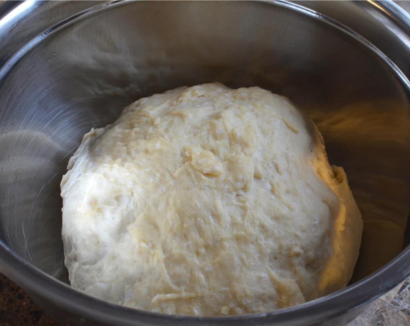 step 5 Place the dough in a well oiled bowl and turn it over to coat the dough in oil. Cover with cling film and a towel and leave the dough to rise for at 1 1/2 hours.