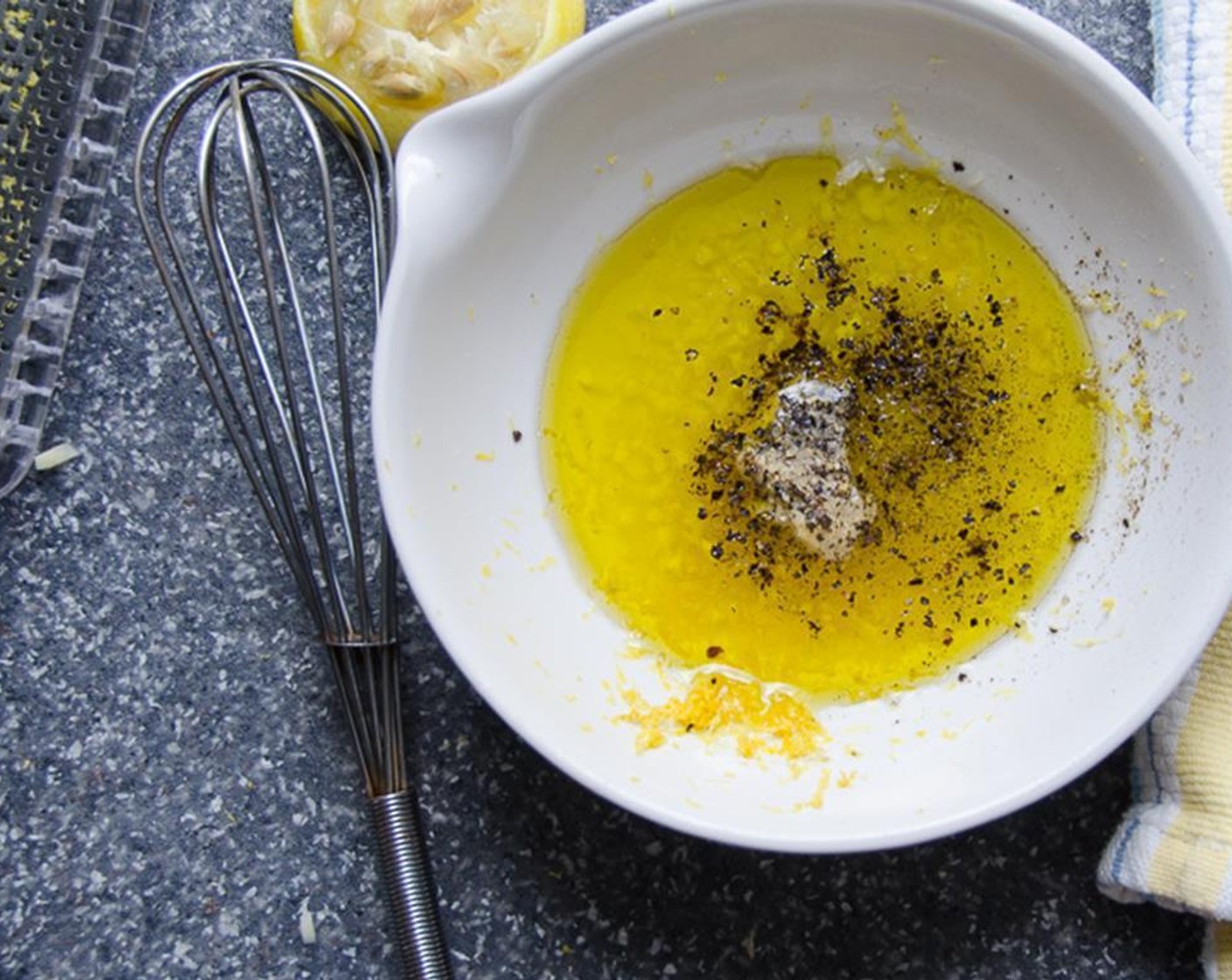 step 6 In a small bowl, zest the Lemon (1) and juice it. Mince the Garlic (1 clove). Then add Dijon Mustard (1 tsp), Olive Oil (4 Tbsp), Kosher Salt (1/2 tsp) and Ground Black Pepper (1/4 tsp). Whisk together until emulsified.