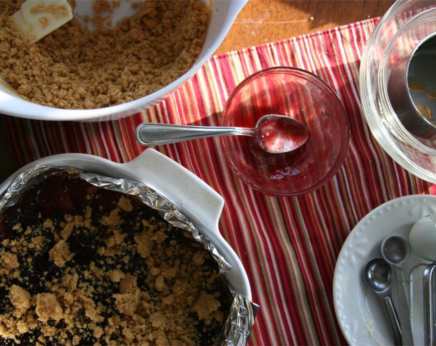 step 5 Pour 3/4 of the mixture into the prepared pan and press down with your fingers. Pour Raspberry Preserves (1/2 cup) over this layer and crumble remaining batter over top.